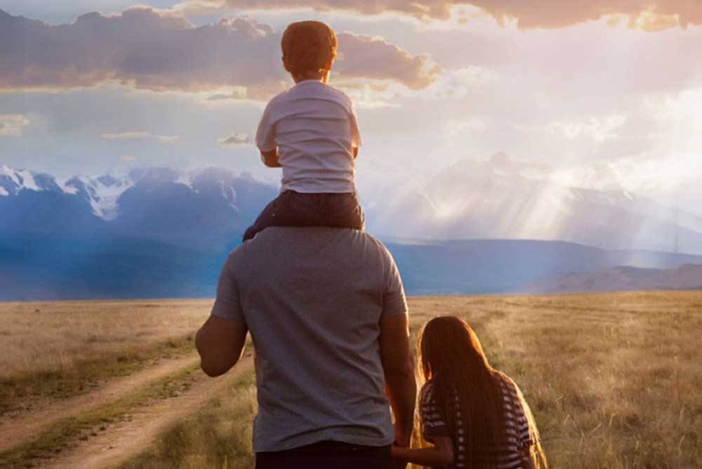 Man with children and one on his shoulders