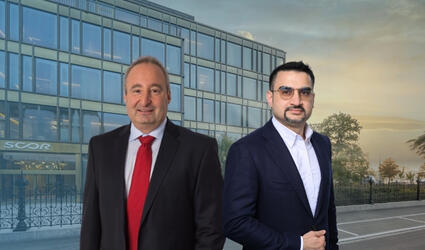 Réné Kunz and Vikas Mahajan with SCOR's Zurich office in the background